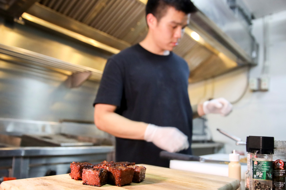 Steaks made from chicken feather are seen next to Thai inventor Sorawut Kittibanthorn at a kitchen in Bangkok, Thailand, December 14, 2020. — Reuters pic
