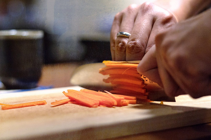 Slice carrots into sticks of even thickness.