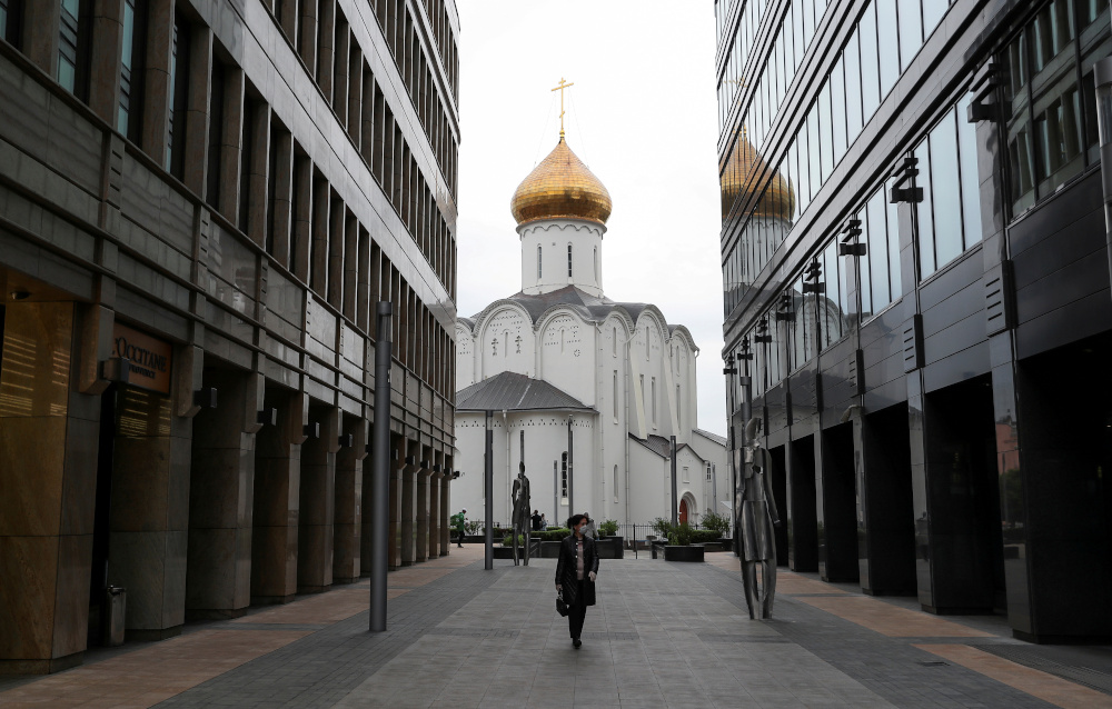 A woman wearing a protective face mask walks in a business district amid the outbreak of the coronavirus disease in Moscow, Russia May 12, 2020. u00e2u20acu201d Reuters picnn