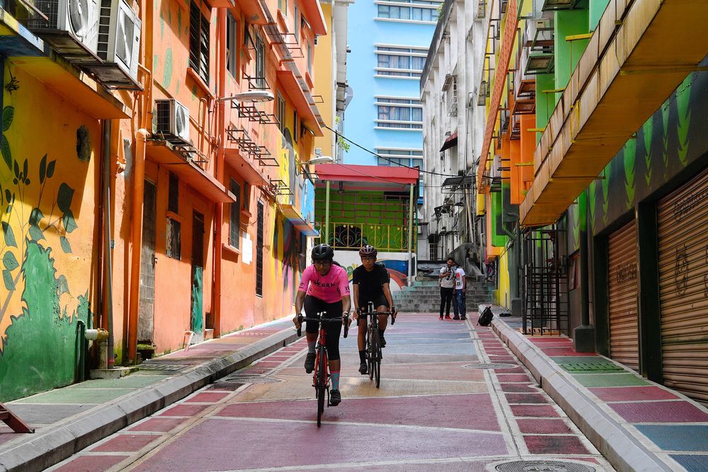 Several cyclists are seen passing through Jalan Alor mural lane, December 13, 2020. — Bernama pic