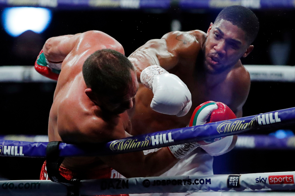 Britainu00e2u20acu2122s Anthony Joshua lands a punch on Bulgariau00e2u20acu2122s Kubrat Pulev (left) during their heavyweight world title boxing match at Wembley Arena in north-west London December 12, 2020. u00e2u20acu201d AFP picnn