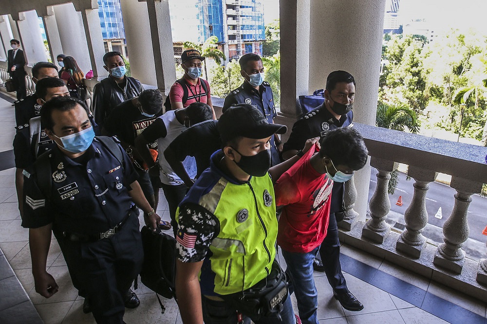 Four men who murdered ex-Mardi researcher Wan Hassan Wan Embong are seen at the Kuala Lumpur Court Complex December 9, 2020. u00e2u20acu201d Picture by Hari Anggara