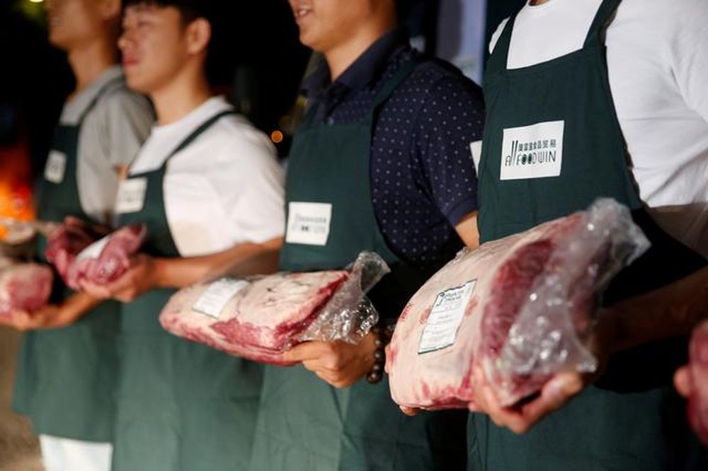 File picture shows employees of Shanghai All Food Win Co, posing with beef at a storage area near the Pudong International Airport in Shanghai, China, June 28, 2017. u00e2u20acu201d Reuters pic