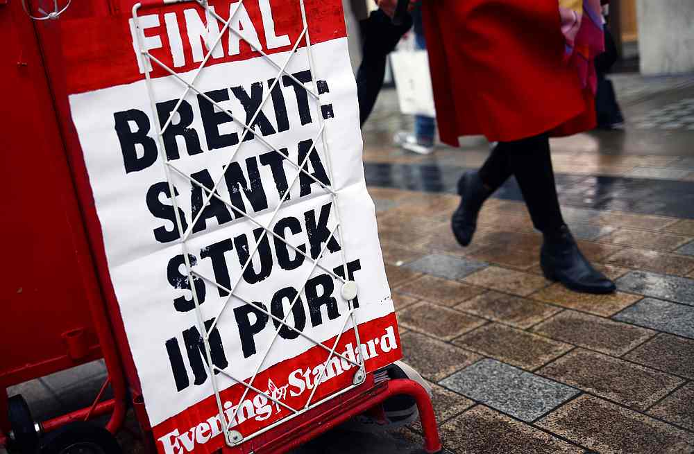 A sign is seen as shoppers walk down the street in London, Britain December 18, 2020. u00e2u20acu201d Reuters pic