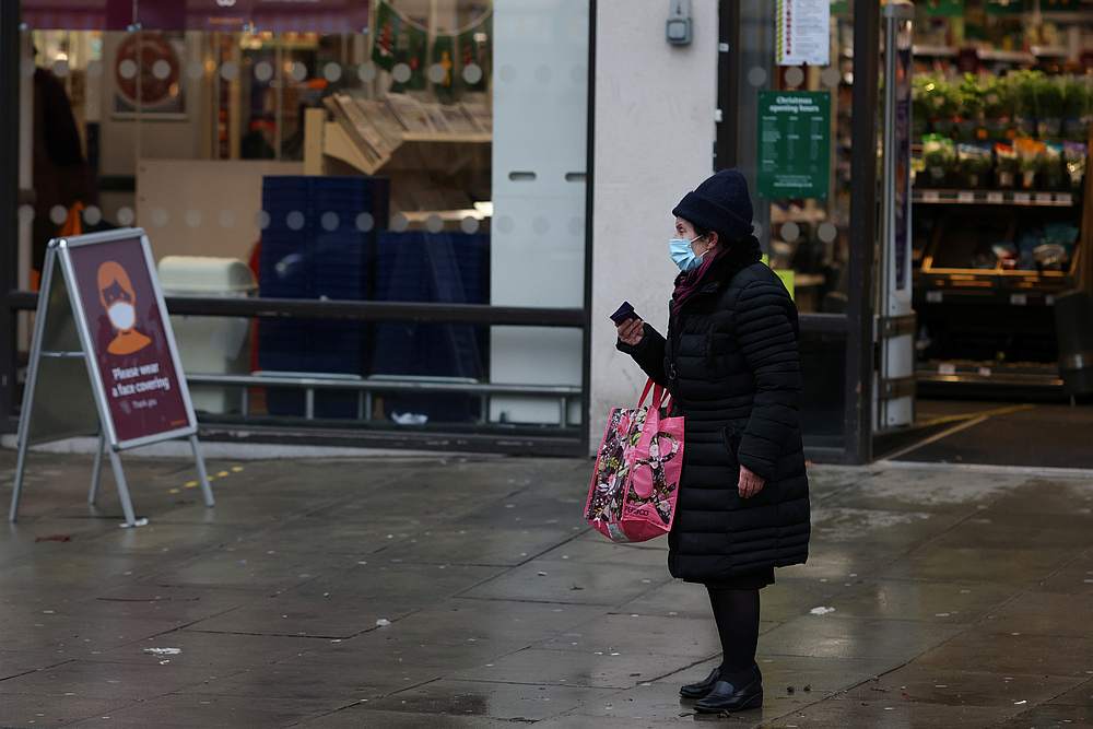 A woman wearing a face mask waits for a bus outside a supermarket as EU countries impose a travel ban from the UK amid alarm about a rapidly spreading strain of coronavirus, in Fulham, London, Britain December 21, 2020. u00e2u20acu201d Reuters pic