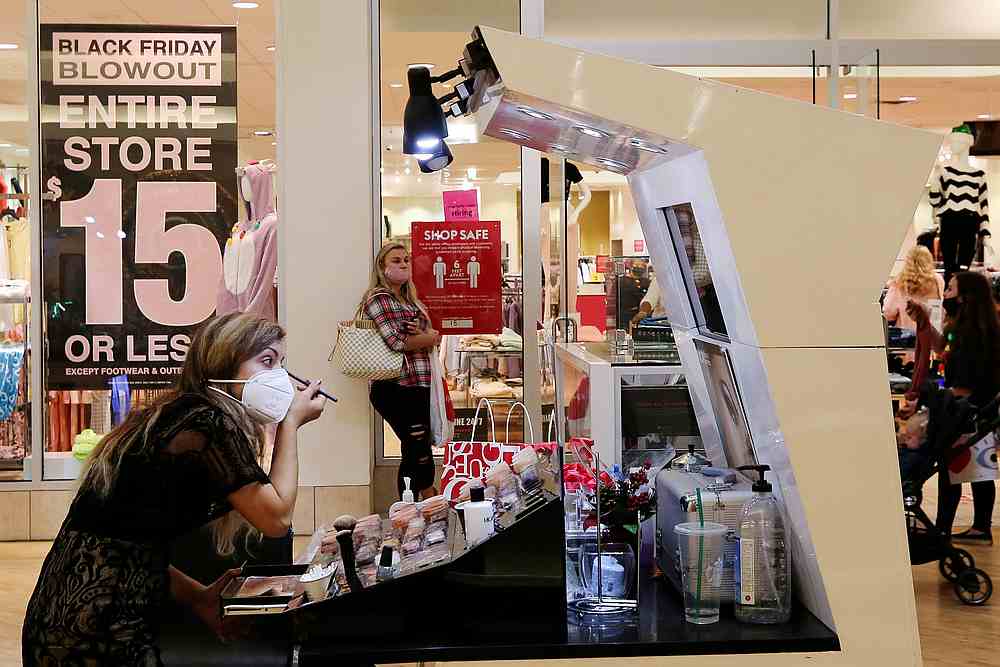 An employee wearing a protective mask applies makeup at Coastal Grand Mall on Black Friday, as the Covid-19 pandemic continues, in Myrtle Beach, South Carolina November 27, 2020. u00e2u20acu201d Reuters pic