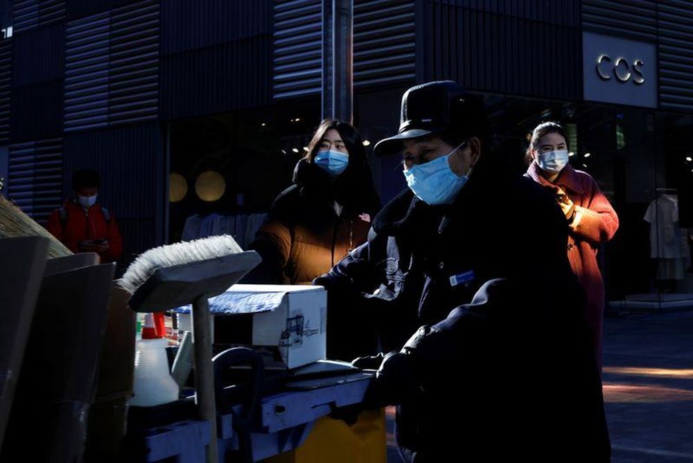 People wear masks as they walk in a shopping district, following an outbreak of the coronavirus disease (Covid-19) in Beijing, China, December 18, 2020. u00e2u20acu201d Reuters pic