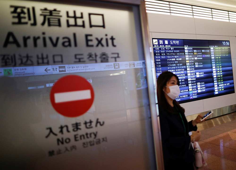 A woman wearing a protective face mask is seen at the arrival gate of the international flight terminal at Tokyo International Airport, Japan December 28, 2020. u00e2u20acu201d Reuters pic