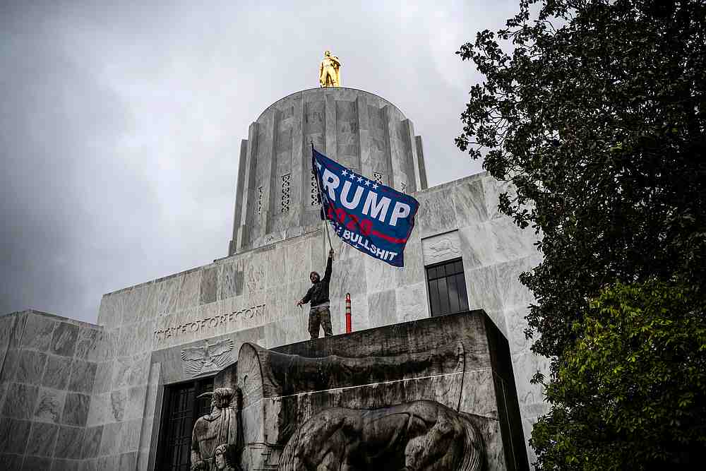 A far-right protester waves a Trump flag in front of the Capitol building during a protest against restrictions to prevent the spread of Covid-19 in Salem, Oregon December 21, 2020. u00e2u20acu201d Reuters pic