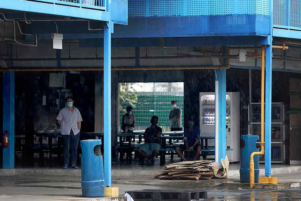 Foreign workers living in Singapore dormitories will still be subjected to routine testing for Covid-19 and they still have to wear their contact-tracing devices called BluePass tokens. u00e2u20acu201d TODAY pic