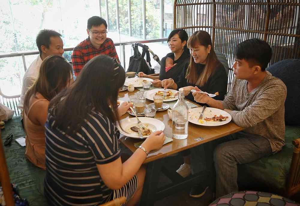 Some people took the opportunity to gather in bigger groups on December 28, 2020, including Tan Jun Hao (far right) and six friends at Wild Honey cafe in Scotts Square, Singapore. u00e2u20acu201d TODAY pic