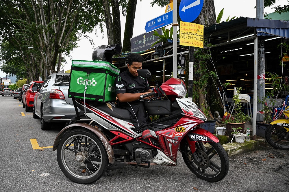 Birth complications left Muhammad Sidek Osman stooped and shorter than average at just 108 centimetres (3.5 feet), making even simple tasks such as climbing stairs a challenge. u00e2u20acu2022 AFP pic