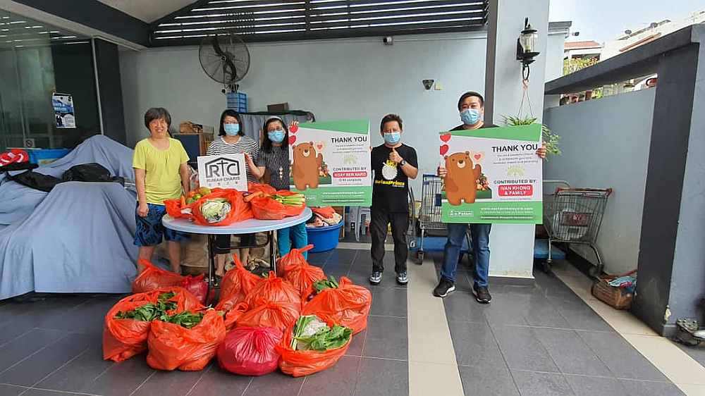 Sumo Eleven and e-Petani representatives distributing packs of daily essentials to Rumah Charis in Kuala Lumpur. — Picture courtesy of Erik Ong 