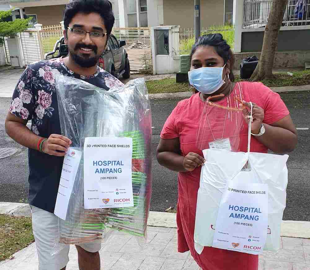 Vishan delivering 100 face shields to a volunteer to be distributed to Ampang Hospital. — Picture by Vishan Nair