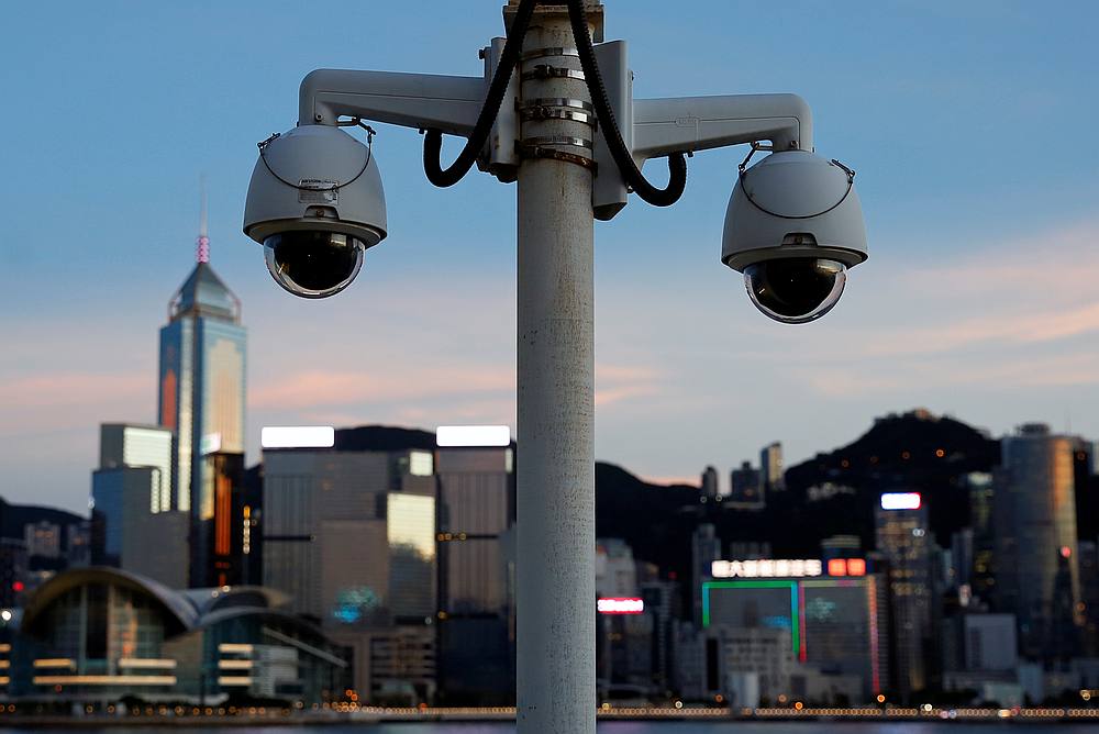 A pair of surveillance cameras seen along the Tsim Sha Tsui waterfront as skyline buildings stand across Victoria Harbour in Hong Kong July 28, 2020. u00e2u20acu201d Reuters pic
