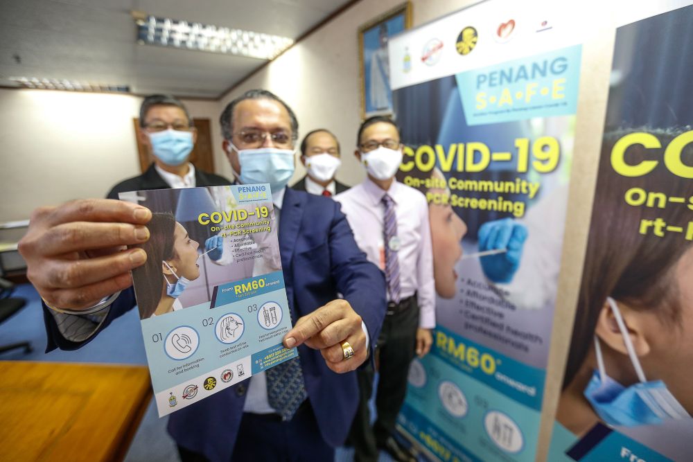 Penang exco Jagdeep Singh Deo holds up a brochure on mass Covid-19 screening during a press conference at Komtar, George Town December 24, 2020. u00e2u20acu201d Picture by Sayuti Zainudinnn