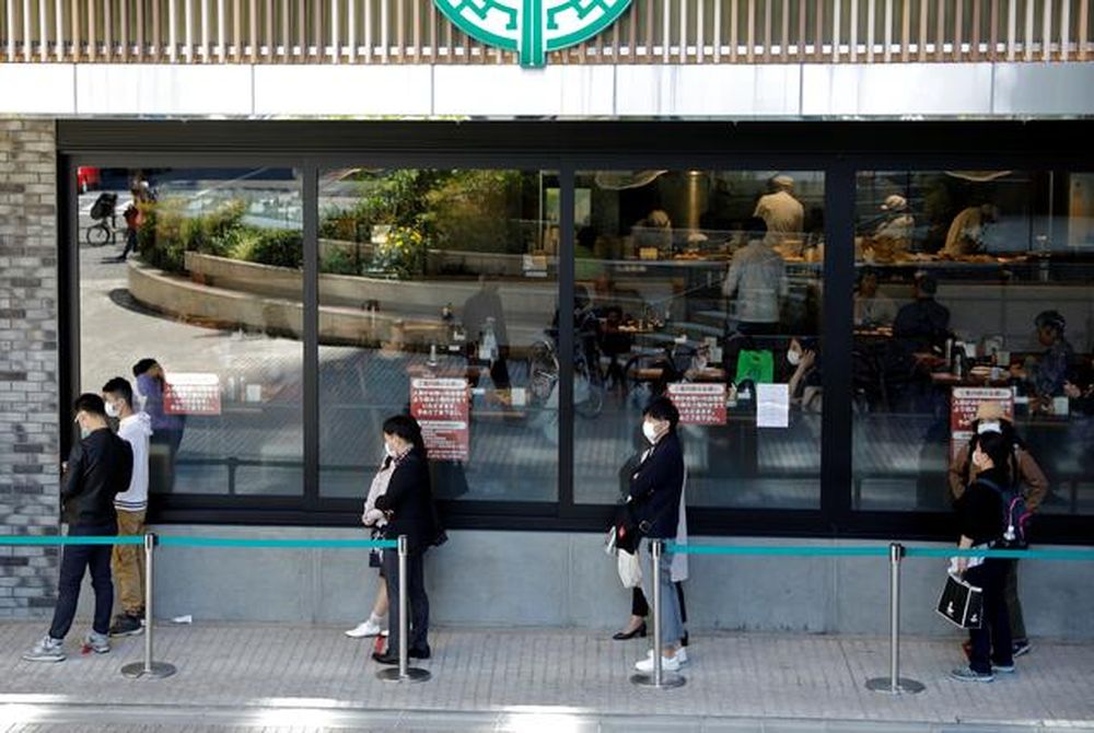 People wearing face masks stand in a queue during the nationwide state of emergency following the coronavirus disease (Covid-19) outbreak in Tokyo, Japan, April 25, 2020. u00e2u20acu201d Reuters pic