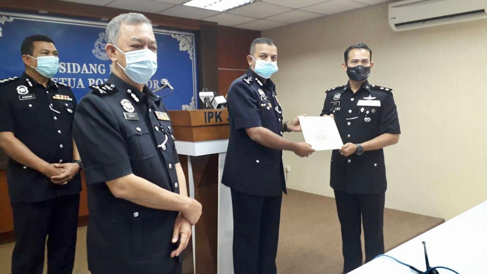 Johor police chief Datuk Ayob Khan Mydin Pitchay (centre) after giving out integrity commendation letters to police officers at the Johor police contingent headquarters in Johor Baru December 3, 2020. u00e2u20acu201d Picture by Ben Tan
