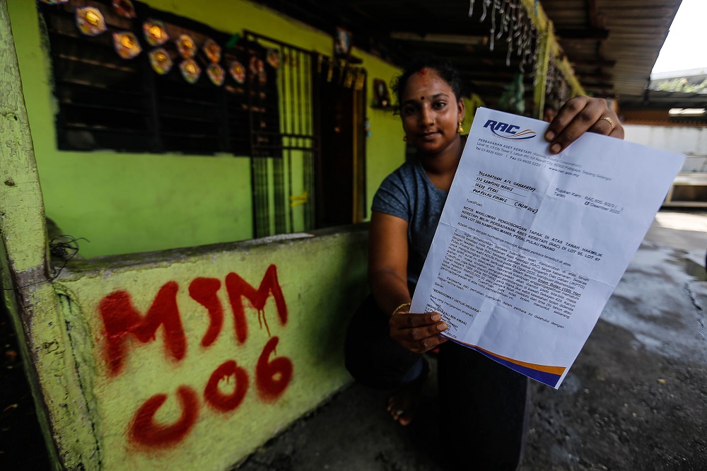 M. Letchumanie, 25, showing the notice of eviction at Kampung Manis on December 16, 2020. 