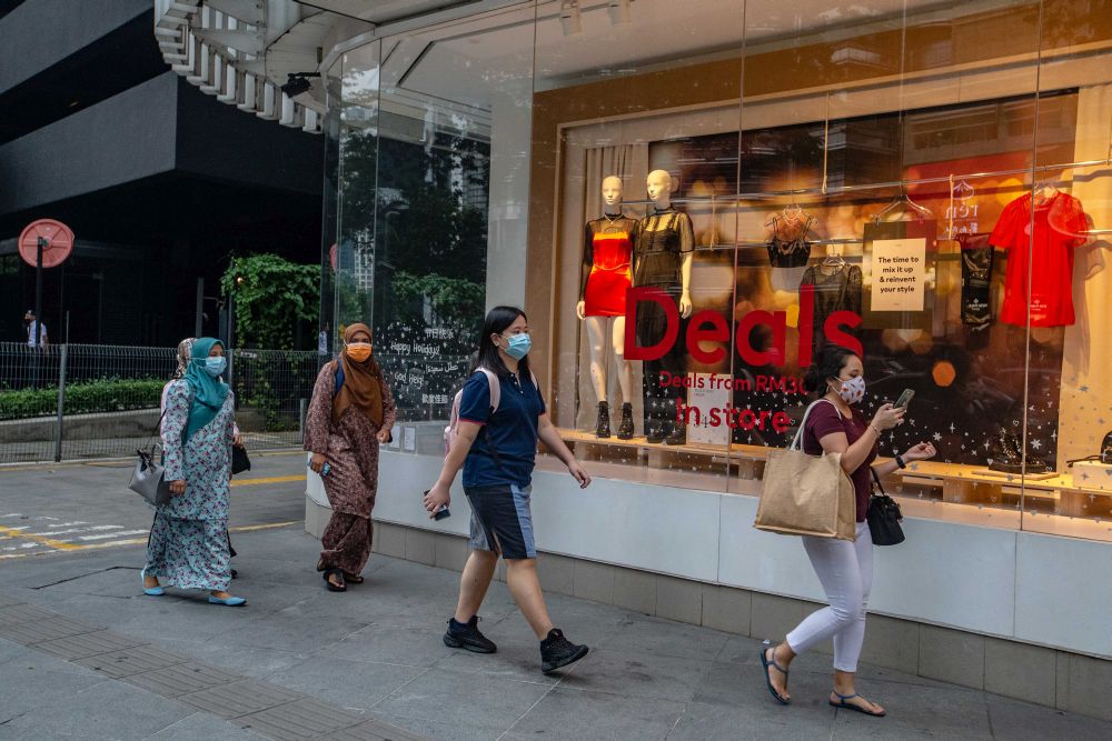People wearing face masks are pictured walking along Jalan Ampang in Kuala Lumpur December 23, 2020. u00e2u20acu201d Picture by Firdaus Latif