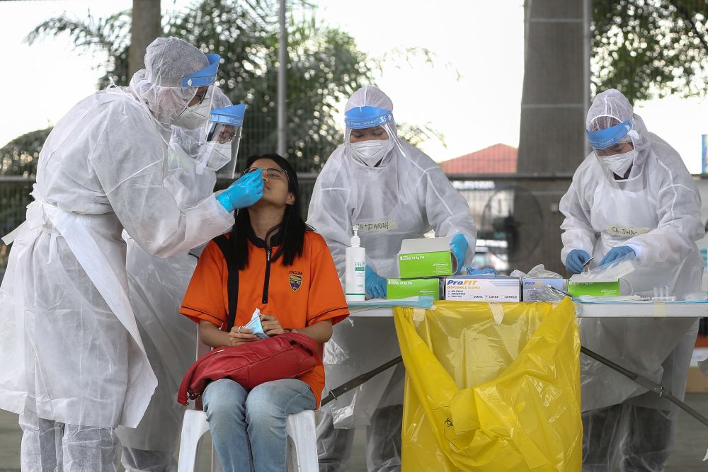 Health workers collect swab samples to test for Covid-19 at Dewan MPK Meru in Klang December 20, 2020. u00e2u20acu201d Picture by Yusof Mat Isa