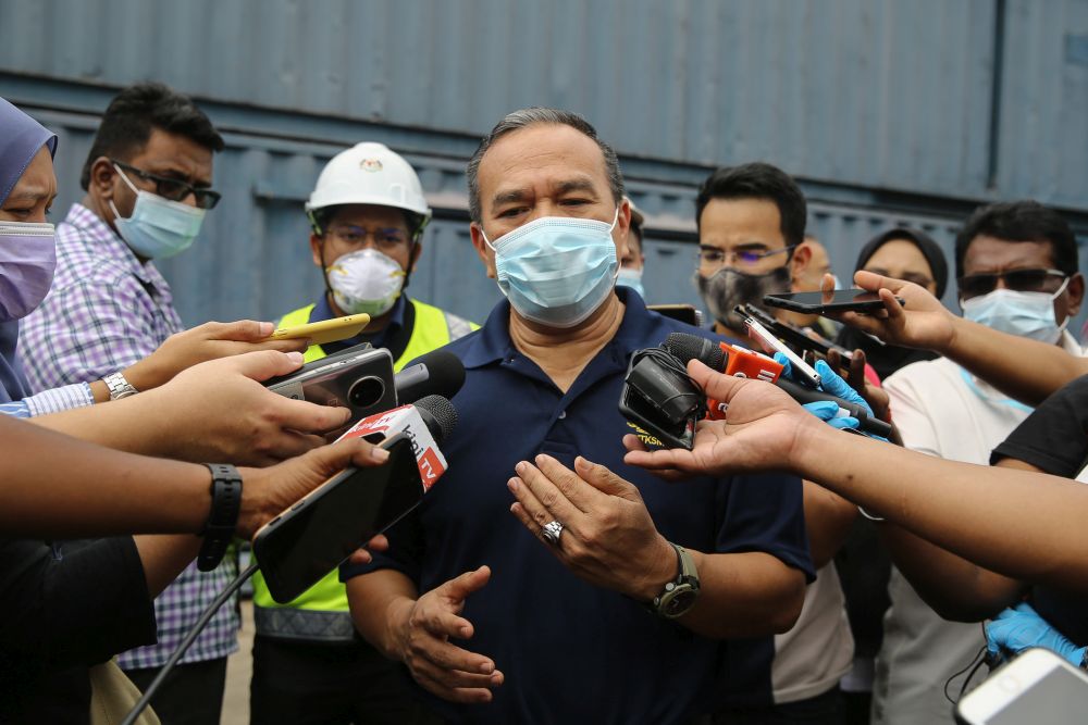 Human Resources Ministry deputy director-general Mohd Asri Abdul Wahab speaks to reporters following a raid on the premises of a glove manufacturer in Klang December 24, 2020. — Picture by Yusot Mat Isa