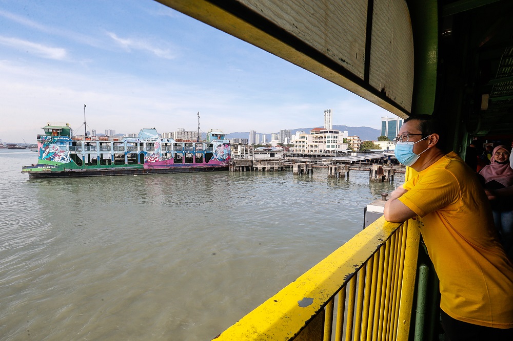 Lim Guan Eng boards the ferry service for the last time at the Pengkalan Raja Tun Uda Terminal  December 31, 2020.  ― Picture  by Sayuti Zainudin