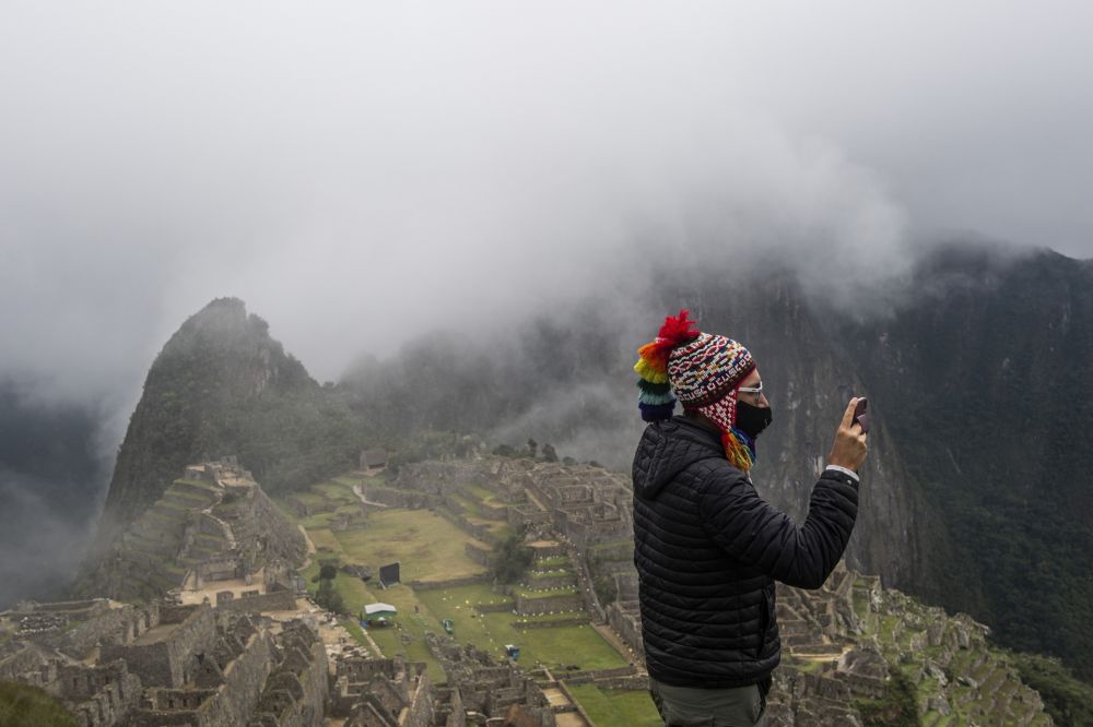 A tourist poses for a selfie in front of the archaeological site of Machu Picchu, in Cusco, Peru. u00e2u20acu201d AFP pic