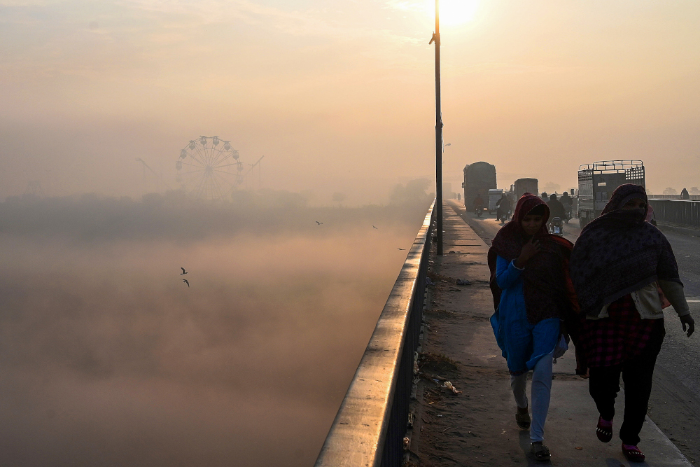 People make their way amid heavy smoggy conditions in Lahore December 7, 2020. u00e2u20acu201d AFP pic 