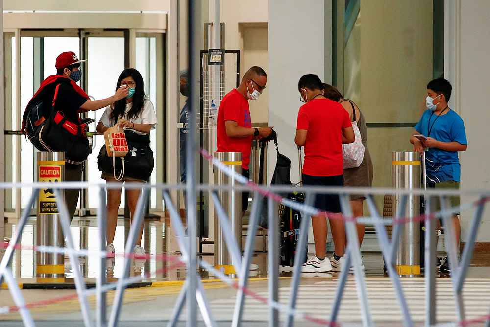 Passengers leave Marina Bay Cruise Centre after disembarking from the Royal Caribbean's Quantum of the Seas cruise ship, in Singapore December 9, 2020. u00e2u20acu201d Reuters pic