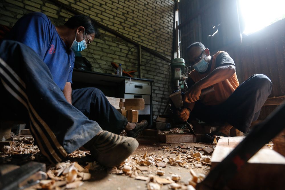 Mohd Sobri Yusof (right), owner of Malata Woodwork, at his workshop in Kepala Batas December 15, 2020.  — Picture by Sayuti Zainudin