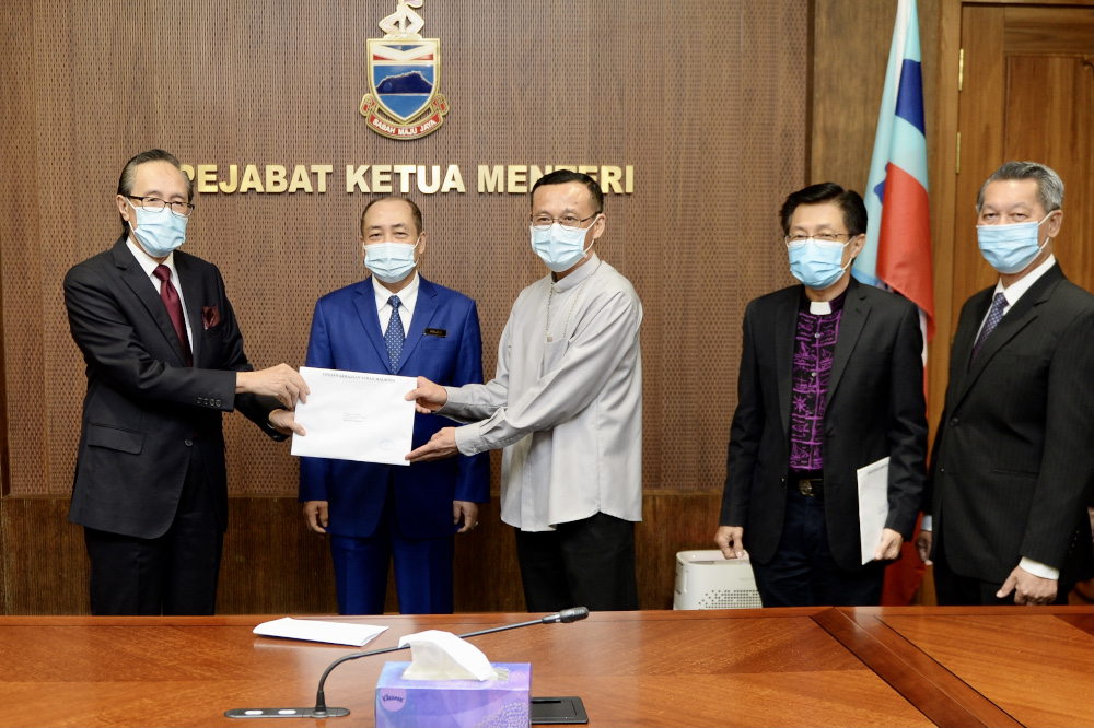 (From left) Datuk Masidi Manjun, Sabah CM Datuk Seri Hajiji Noor, Archbishop Datuk John Wong, SCC President Bishop James Wong and Datuk Jerry Dusing at the cheque presentation ceremony December 16, 2020. u00e2u20acu201d Picture by Chief Ministeru00e2u20acu2122s Dept