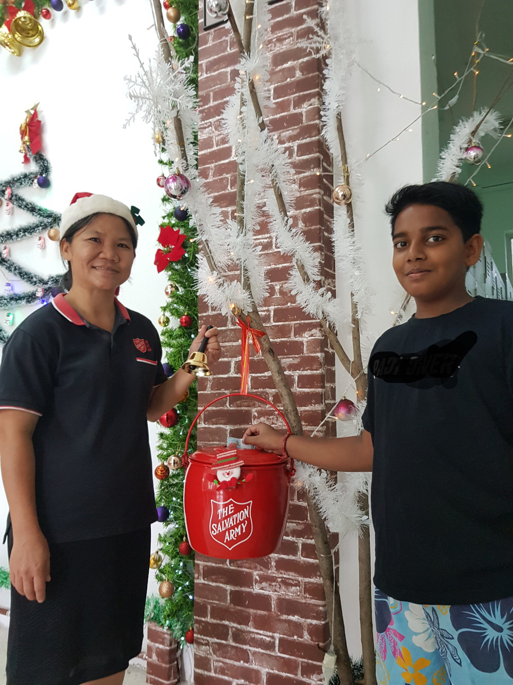 Members of the Salvation Army Malaysia with their red kettle. u00e2u20acu201d Picture courtesy of Salvation Army Malaysia