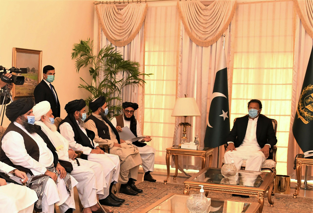 This handout photograph taken December 18, 2020 shows Pakistani Prime Minister Imran Khan along with Taliban co-founder Mullah Abdul Ghani Baradar (5th left) and his delegation during their meeting in Islamabad. u00e2u20acu201d Pakistan Prime minister office handout 