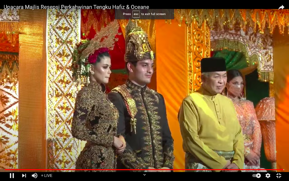 Datuk Seri Tengku Adnan Mansor’s son Muhammad Hafiz (centre) and wife Oceane Cyril Alogia (left) pose with Datuk Seri Ahmad Zahid Hamidi at their wedding reception December 20, 2020. — Screenshot from https://hafizoceane.com/live/
