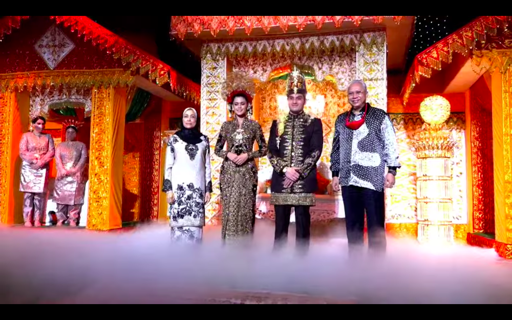 Datuk Seri Tengku Adnan Mansor’s son Muhammad Hafiz and wife Oceane Cyril Alogia pose for a picture with Tan Sri Annuar Musa and his wife at their wedding reception December 20, 2020. — Screenshot from https://hafizoceane.com/live/