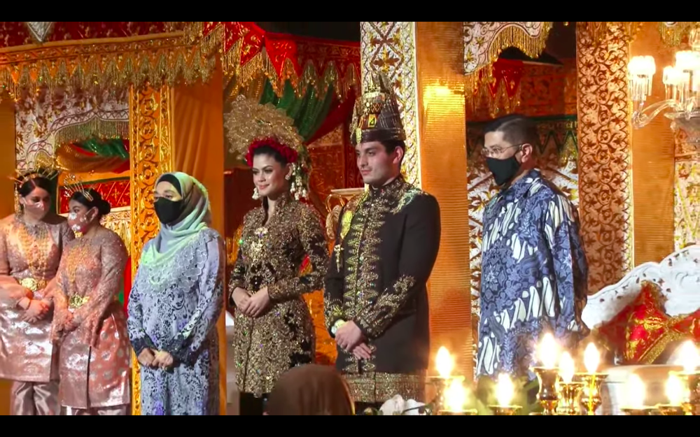 Datuk Seri Tengku Adnan Mansor’s son Muhammad Hafiz and wife Oceane Cyril Alogia pose for a picture with Datuk Seri Azmin Ali and his wife at their wedding reception December 20, 2020. — Screenshot from https://hafizoceane.com/live/