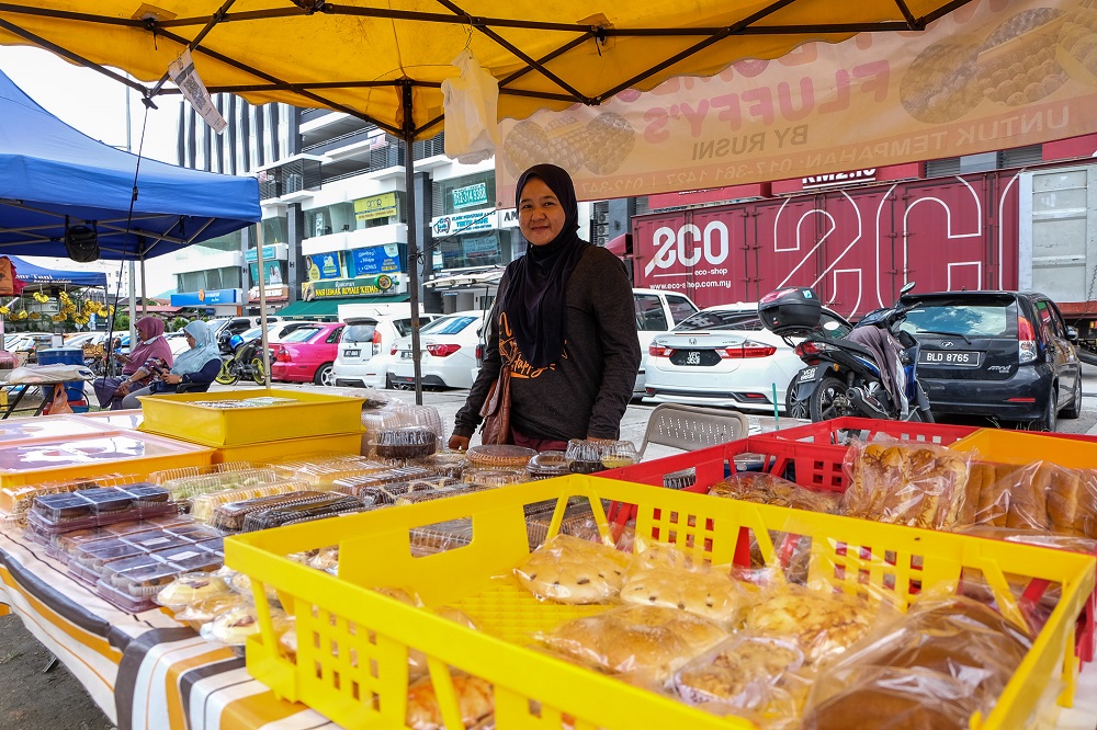 Food vendor Tutik Sutan Bujang, 38, poses for a picture at her roadside stall in Kuala Lumpur December 28, 2020. 