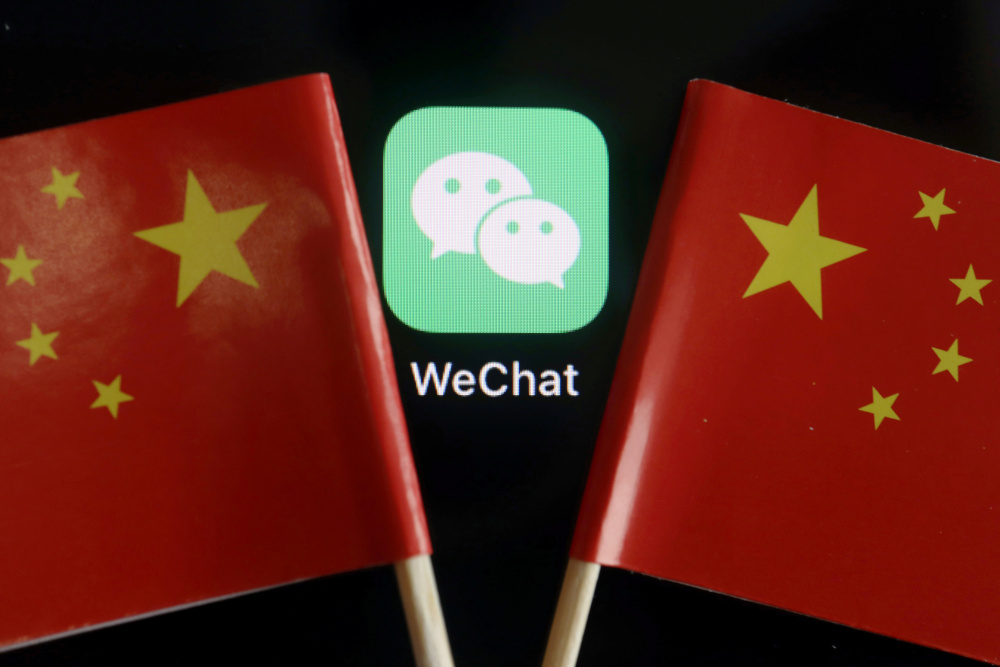The messenger app WeChat is seen in between China flags in this illustration picture taken August 7, 2020. u00e2u20acu201d Reuters picnn