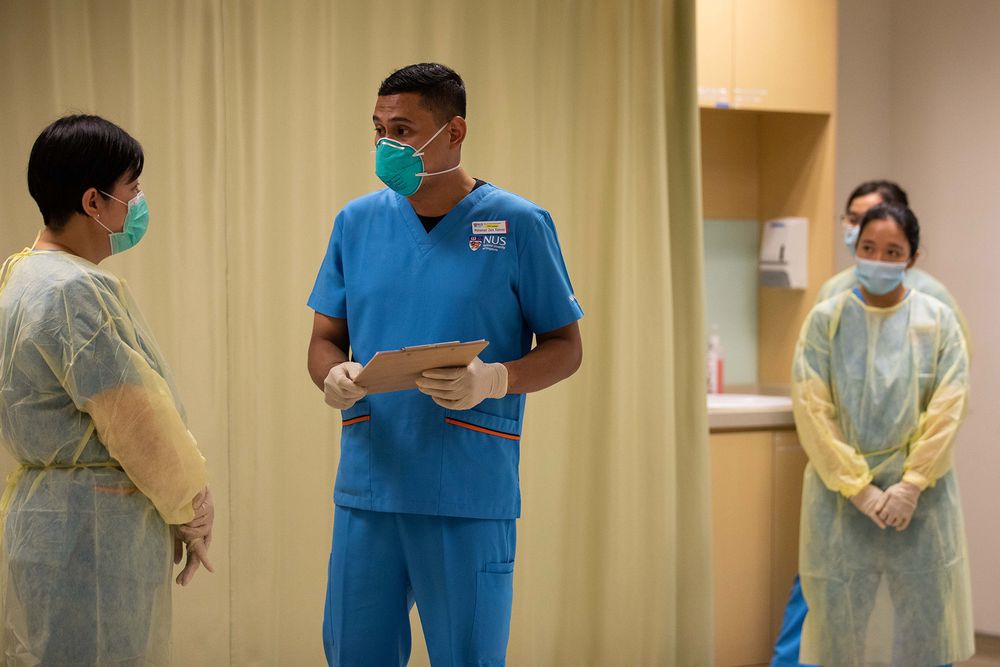 Mid-career nursing student Mohamad Zaid Rahmat (centre) during a simulation session on emergency nursing care. — TODAY pic