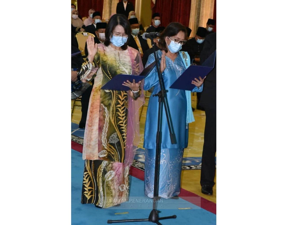 Julita (left) and Flovia during the swearing in ceremony at Istana Negeri, yesterday. u00e2u20acu201d Borneo Post Online pic