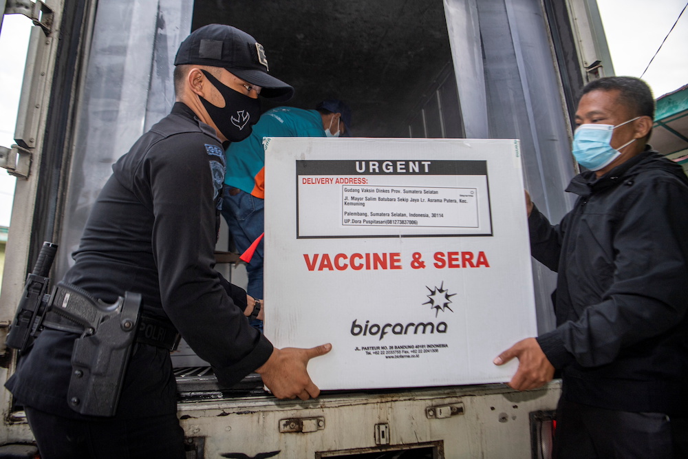 Officers offload a box of Sinovac's vaccine for Covid-19 as it arrives at the cold room of Indonesia's local health department in Palembang January 4, 2021. u00e2u20acu201d Antara Foto/Nova Wahyudi via Reuters