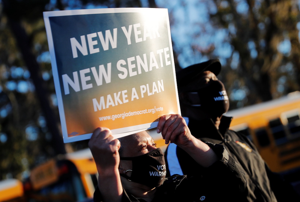 A supporter of Democratic US Senate candidate Raphael Warnock holds up a sign a campaign event ahead of Georgia's runoff elections in Savannah, Georgia January 3, 2021. u00e2u20acu201d Reuters pic