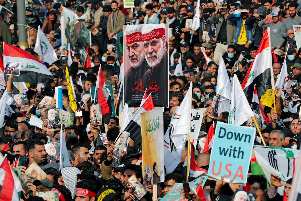 Iraqis hold placards and flags as they gather to mark the one-year anniversary of the US killing of senior Iranian military commander General Qassem Soleimani and Iraqi militia commander Abu Mahdi al-Muhandis, in Baghdad January 3, 2021. u00e2u20acu201d Reuters pic