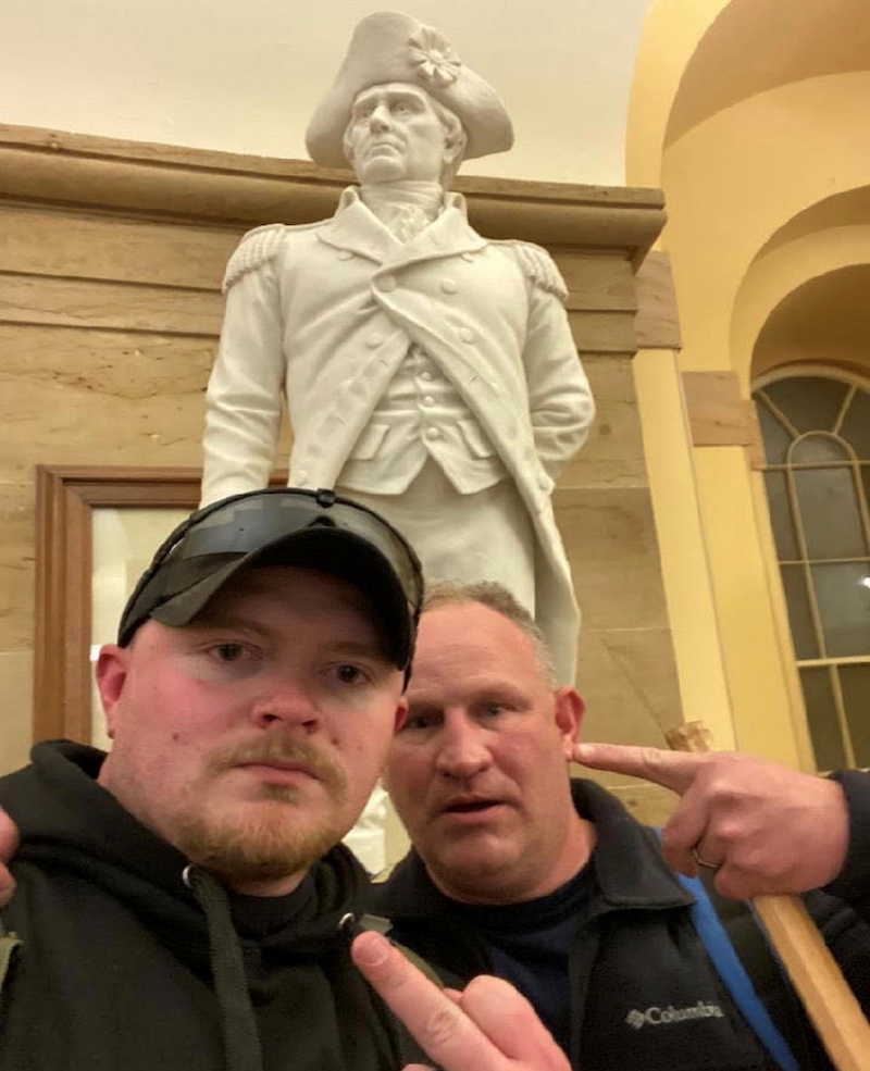 Jacob Fracker and Thomas Robertson, off-duty Rocky Mount, Virginia police officers, gesture in a selfie during the storming of the US Capitol in Washington January 6, 2021. u00e2u20acu201d US Attorney's Office for the District of Columbia handout via Reuters