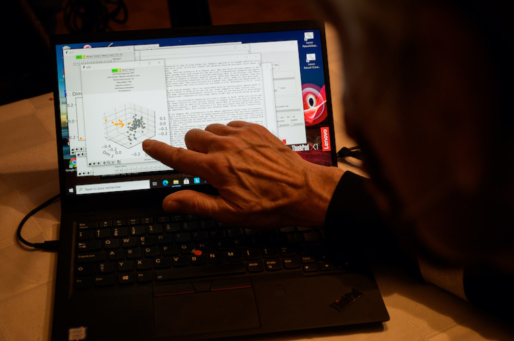 Swiss startup OrphAnalytics staff poses with a laptop using the text analysis software on January 6, 2021. u00e2u20acu201d AFP pic