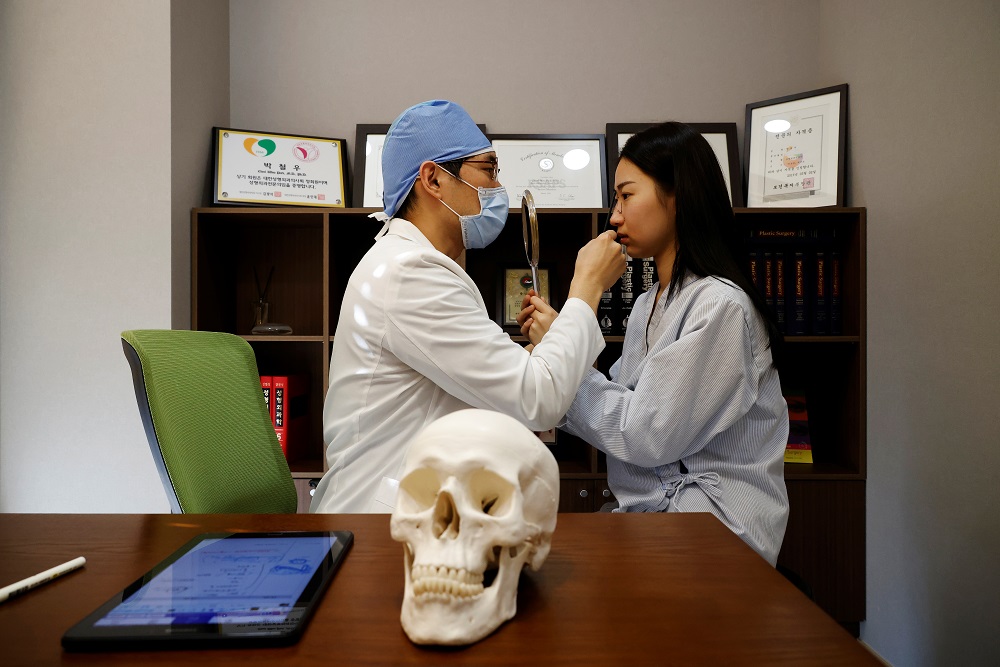 Ryu Han-na consults with Park Cheol-woo a director of WooAhIn Plastic Surgery Clinic before undergoing nose plastic surgery amid the Covid-19 pandemic in Seoul December 17, 2020. u00e2u20acu201d Reuters pic