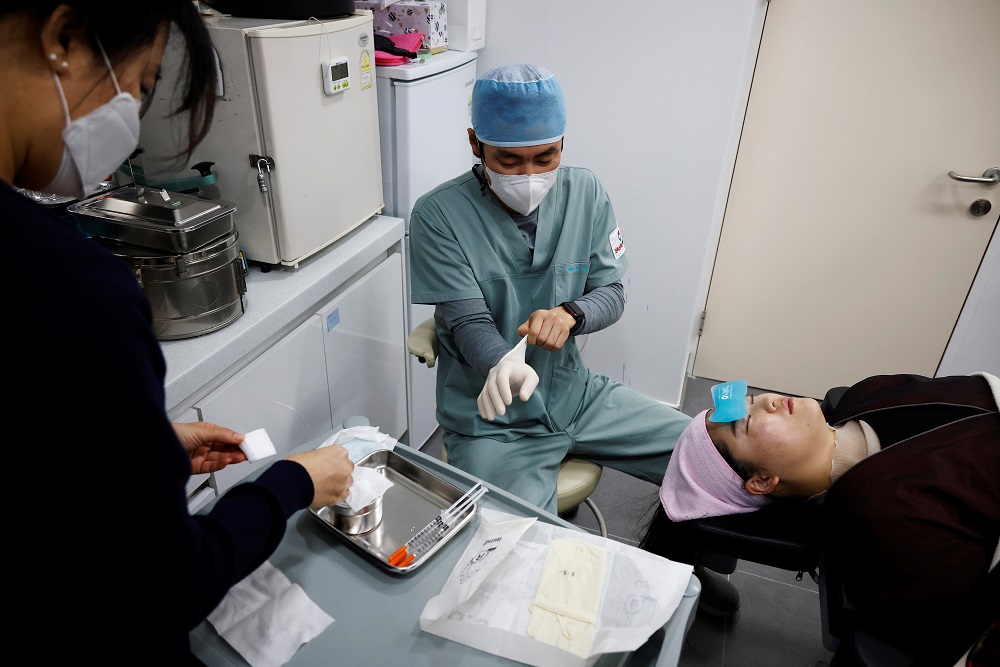 Shin Sang-ho, Director of Krismas Plastic Surgery, prepares to conduct Botox injection, amid the Covid-19 pandemic in Seoul December 15, 2020. — Reuters pic