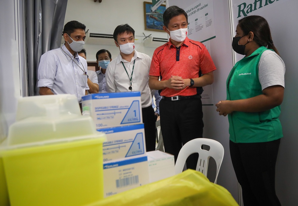 Singapore Trade and Industry Minister Chan Chun Sing (second from right) speaking to a nurse who will be administering vaccines to seniors at Tanjong Pagar Community Club. — TODAY pic