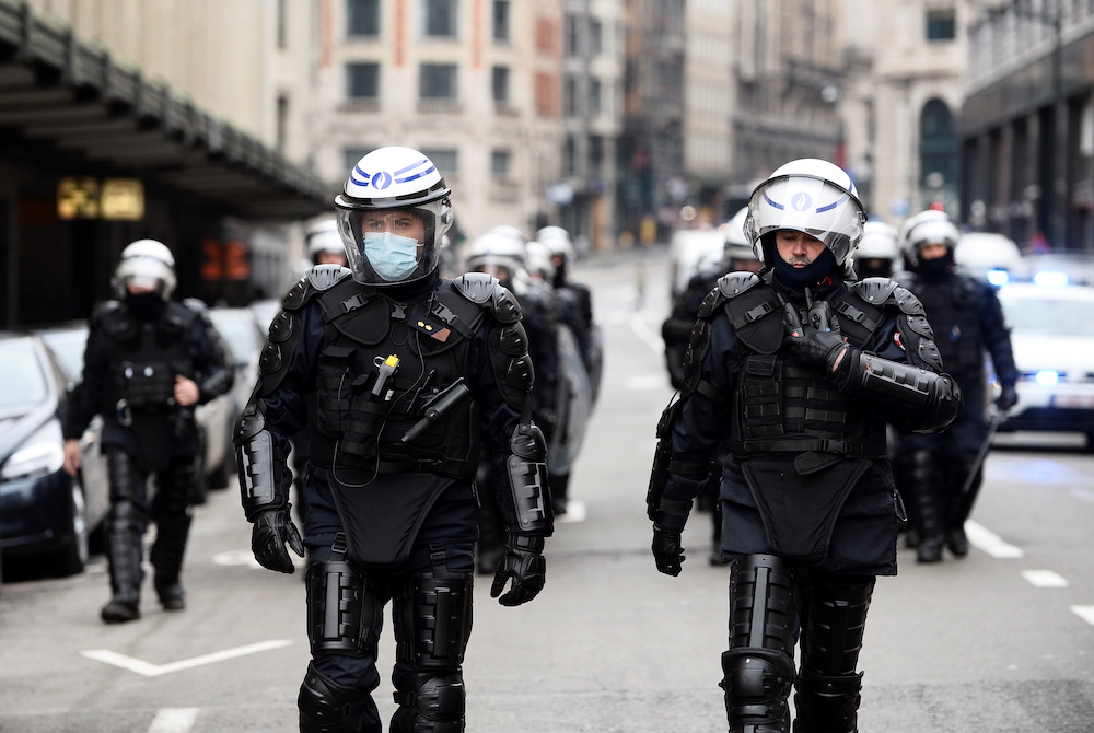 Police officers walk during a demonstration against restrictions put in place to curb the spread of the coronavirus disease (Covid-19) in Brussels, Belgium, January 31, 2021. u00e2u20acu201d Reuters pic